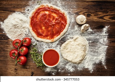 Pizza Dough With Ingredients On Wood, Shot From Above