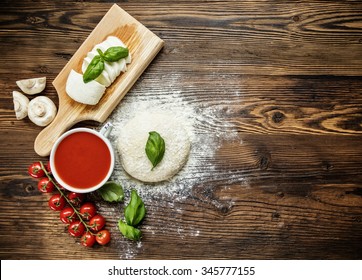 Pizza Dough With Ingredients On Wood, Shot From Above