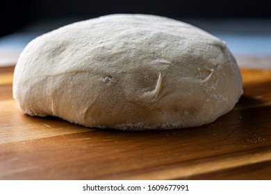 Pizza Dough Proofing On Wooden Pizza Peel. Close Up.