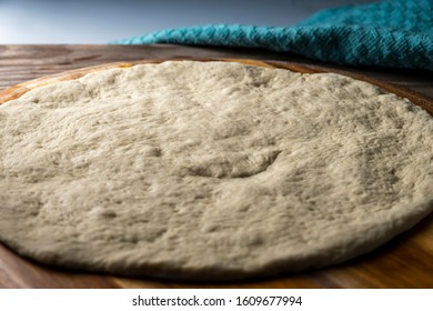 Pizza Dough Proofing On Wooden Pizza Peel. Close Up.