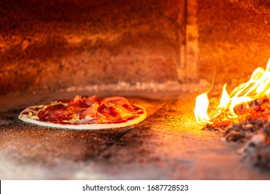 A pizza freshly prepared and traditionally baked in a wood oven