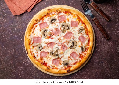 Pizza with ham and mushrooms on concrete table top view