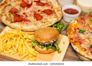 Pizza and hamburger on wooden background - Shutterstock ID 2231436151