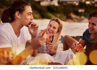 Pizza Is Happy Food. Shot Of A Group Of Friends Sitting Together On The Beach.