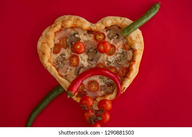 Pizza Heart Shaped With Ham Tomatoes And Mushrooms On Red Background . Sad Face Heartbreak , Concept Of Romantic Love For Valentines Day . Love Food