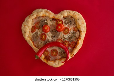 Pizza Heart Shaped With Ham Tomatoes And Mushrooms On Red Background . Sad Face Heartbreak , Concept Of Romantic Love For Valentines Day . Love Food