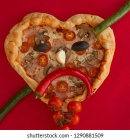 Pizza Heart Shaped With Ham Tomatoes And Mushrooms On Red Background . Sad Face Heartbreak , Concept Of Romantic Love For Valentines Day . Love Food