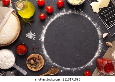 Pizza homemade cooking or baking on table. Dough pizza and flour at slate tabletop background. Recipe concept in kitchen - Shutterstock ID 2118171893
