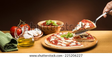 Pizza with ingredients on the wooden table