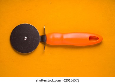 Pizza Knife On The Yellow Table Top View