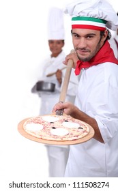 Pizza Maker Displaying His Pizza