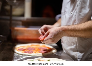 Pizza Making Process. Male Chef Hands Making Authentic Pizza In The Pizzeria Kitchen.