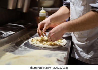 Pizza Making Process. Male Chef Hands Making Authentic Pizza In The Pizzeria Kitchen.