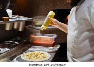 Pizza Making Process. Male Chef Hands Making Authentic Pizza In The Pizzeria Kitchen.