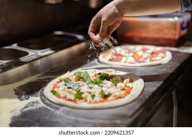 Pizza Making Process. Male Chef Hands Making Authentic Pizza In The Pizzeria Kitchen.