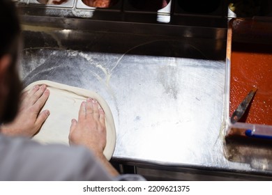 Pizza Making Process. Male Chef Hands Making Authentic Pizza In The Pizzeria Kitchen.