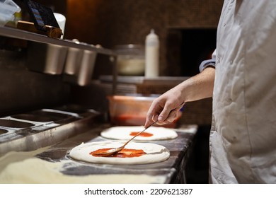 Pizza Making Process. Male Chef Hands Making Authentic Pizza In The Pizzeria Kitchen.