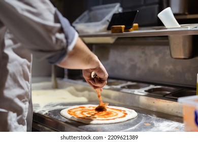 Pizza Making Process. Male Chef Hands Making Authentic Pizza In The Pizzeria Kitchen.