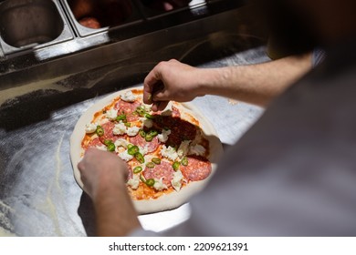 Pizza Making Process. Male Chef Hands Making Authentic Pizza In The Pizzeria Kitchen.