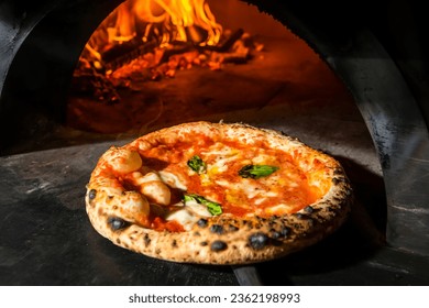 Pizza Margherita (Neapolitan pizza) straight from a wood-fired oven. Close-up, baked in a wood-fired pizza oven. Macro. Interior. Italian cuisine.