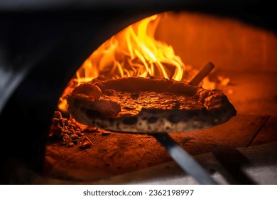 Pizza Margherita (Neapolitan pizza) straight from a wood-fired oven. Close-up, baked in a wood-fired pizza oven. Macro. Interior. Italian cuisine. - Powered by Shutterstock