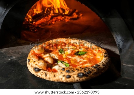 Pizza Margherita (Neapolitan pizza) straight from a wood-fired oven. Close-up, baked in a wood-fired pizza oven. Macro. Interior. Italian cuisine.