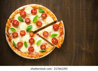 Pizza Margherita on dark wooden background top view - Powered by Shutterstock