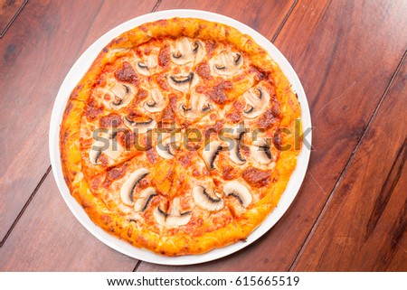 Pizza mushrooms on a wooden table