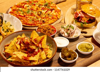 Pizza, Nachos, Pasta And Burger On The Table