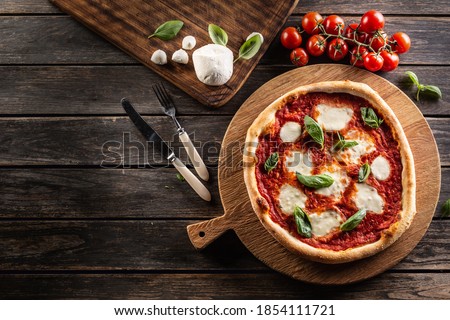 Pizza Napoletana - Napoli tomato sauce mozzarella and basil - top of view.