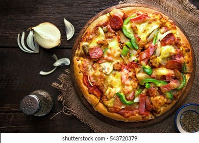 pizza on a rustic wooden table. Top view
