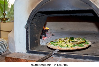 
pizza on the shovel in the wood oven, vegetable