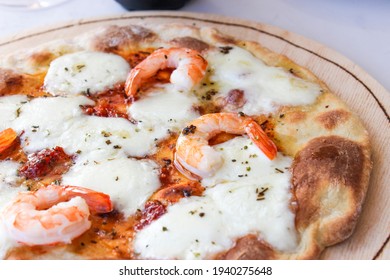 Pizza on a wooden board with mozzarella, mini arugula. - Powered by Shutterstock