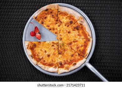 A Pizza Pan With Strawberries On A Black Knitting Table