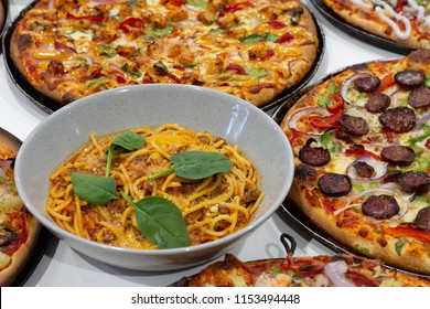 Pizza And Pasta On A Table 