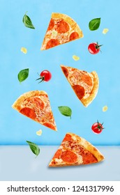 Pizza with pepperoni, tomato sauce and cheese on a blue background. toning. selective focus - Shutterstock ID 1241317996
