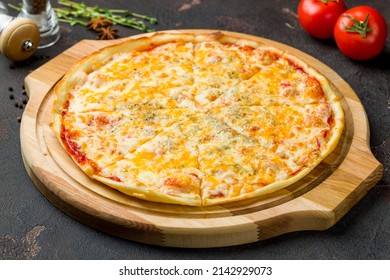 Pizza Quattro formaggi on dark concrete table