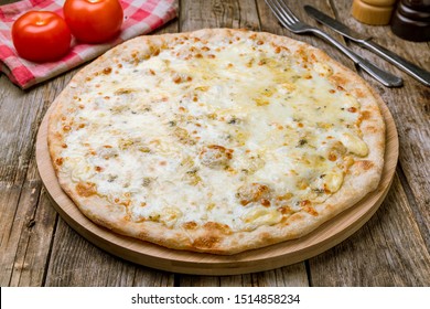 Pizza Quattro formaggi on wooden table
