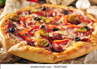 Pizza Restaurant Menu - Delicious Spicy Pizza with Sausages and Chili Pepper. Pizza on Rustic Wooden Table with Ingredients. - Powered by Shutterstock