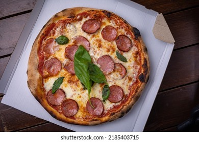 Pizza With Salami, Chees, Tomatoes And Basil. Fast Food. Street Food 