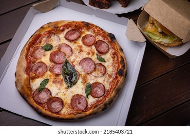 Pizza With Salami, Chees, Tomatoes And Basil. Fast Food. Street Food 