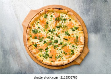 Pizza With Salmon, Cheese And Green Onion On The Board On Grey Table Top View