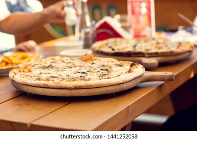 Pizza With Shallow Depth Of Field. Table In A Pizzeria Outside. Beer Garden.