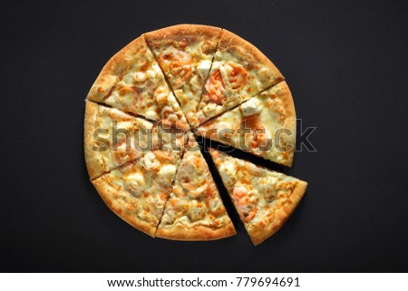 pizza with shrimps tomato cheese on black stone background