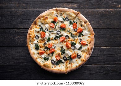 Pizza With Spinach, Feta, Olives And Cherry Tomatoes.