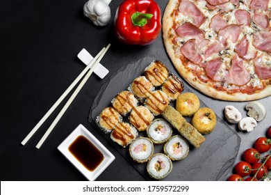 Pizza and sushi rolls tempura and bake rolls on the background of ingredients .Pizza, sushi food photo for menu. Combo set of rolls and pizza.