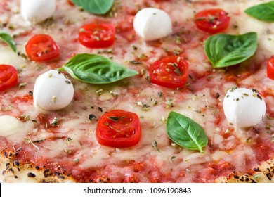 Pizza with tomatoes, cheese and basil. Close up