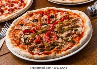 Pizza with tuna fish, bell pepper and olives. - Powered by Shutterstock