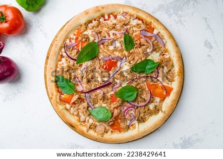 Pizza with tuna and red onion top view on concrete table