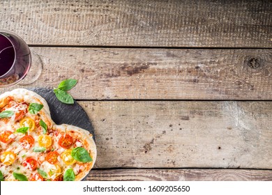 Pizza For Valentine Day. Heart Shaped Homemade Pizza Margarita. Valentines Day Romantic Menu Concept. With Wine Bottle, Roses Flowers And And Wineglass. Wooden Background Copy Space